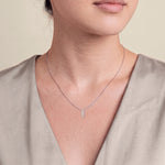 Load image into Gallery viewer, Model wearing the Three Stone Diamond Drop Pendant with Split Bail on a fine chain