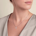 Load image into Gallery viewer, Model wearing the Emerald Cut Diamond Pendant with Small Round Diamond on a fine chain