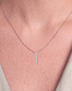 Load image into Gallery viewer, Five Stone Round Diamond Drop Pendant worn – close-up on the collarbone