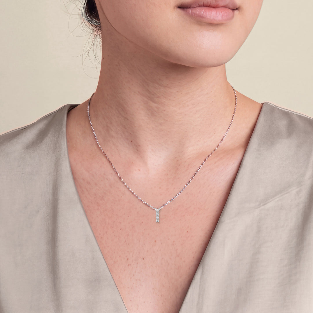 Model wearing the Three Stone Diamond Drop Pendant with Split Bail on a fine chain