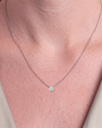 Load image into Gallery viewer, Round Brilliant Rubover Diamond Pendant, High Set worn – close-up on the collarbone