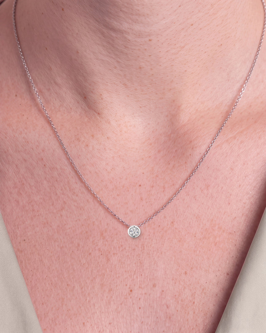 Round Brilliant Rubover Diamond Pendant, High Set worn – close-up on the collarbone