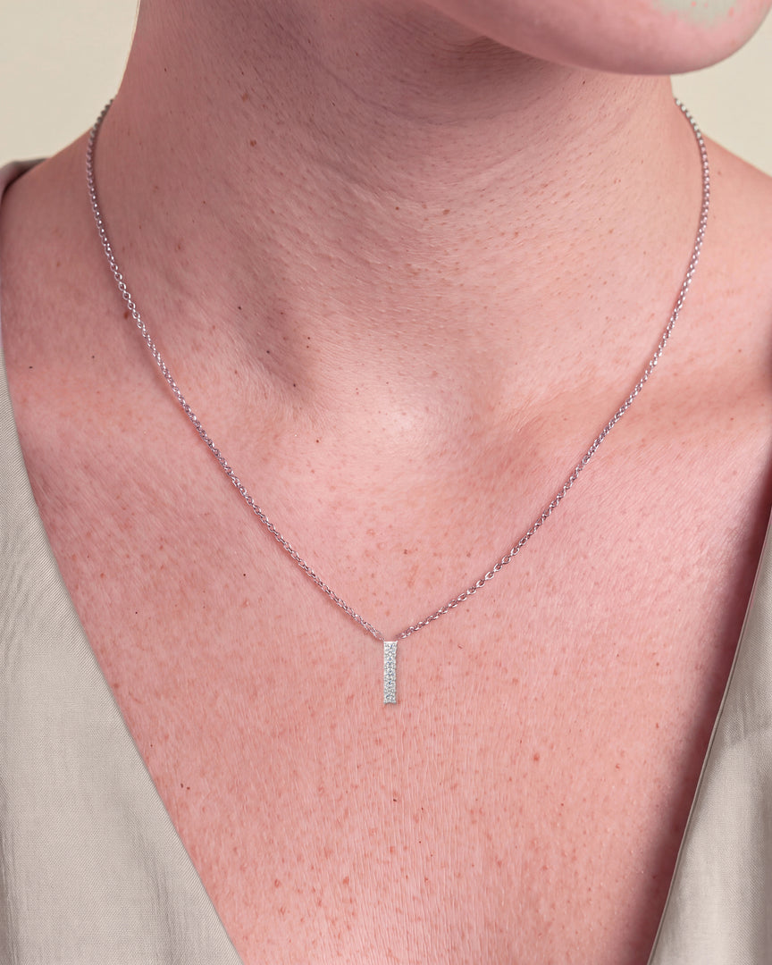 Round Five Stone Diamond Drop Pendant worn – close-up on the collarbone
