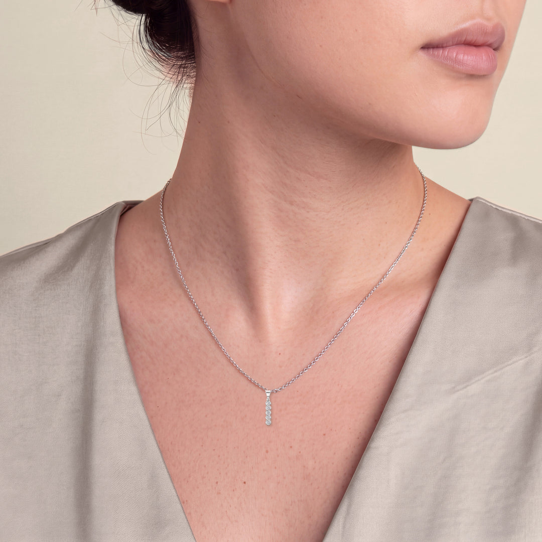 Model wearing the Five Stone Round Diamond Drop Pendant on a fine chain