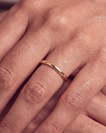 Load image into Gallery viewer, 2mm Traditional Court Wedding Band in 9ct Yellow Gold worn, close-up on the ring finger