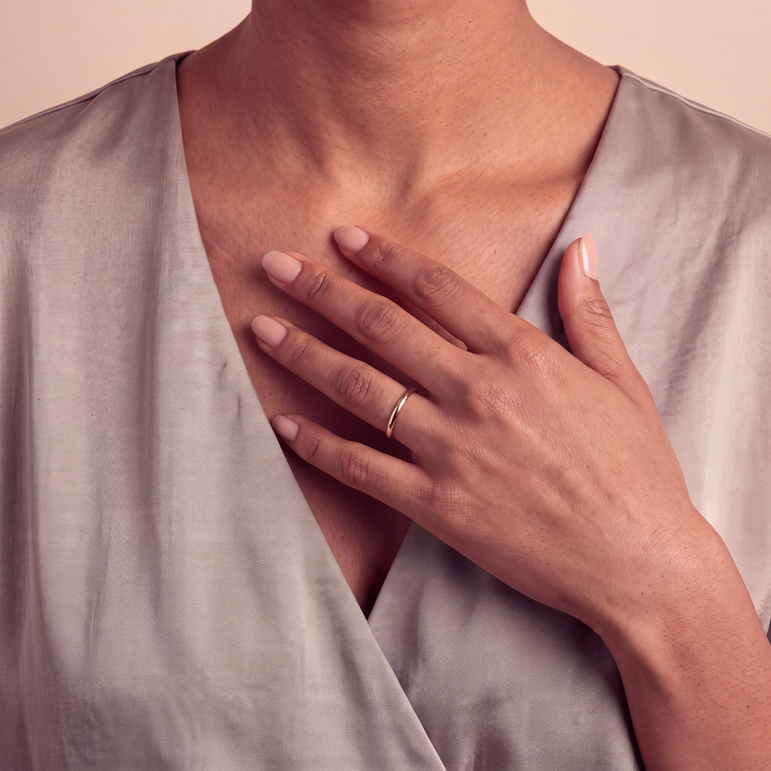 Model wearing the 2mm Traditional Court Wedding Band on her ring finger