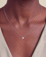 Load image into Gallery viewer, Round Brilliant Rubover Diamond Pendant, Low Set worn – close-up on the collarbone