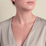 Load image into Gallery viewer, Model wearing the Pear Shaped Style Round Diamond Pendant on a fine chain