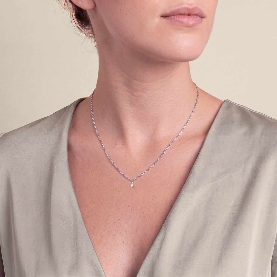 Model wearing the Pear Shaped Style Round Diamond Pendant on a fine chain