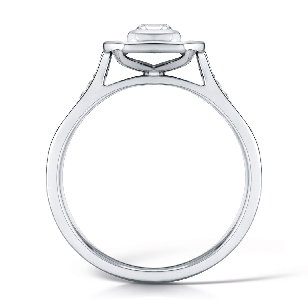 Emerald Cut Diamond Set In A Rubover Grain Set Halo Design