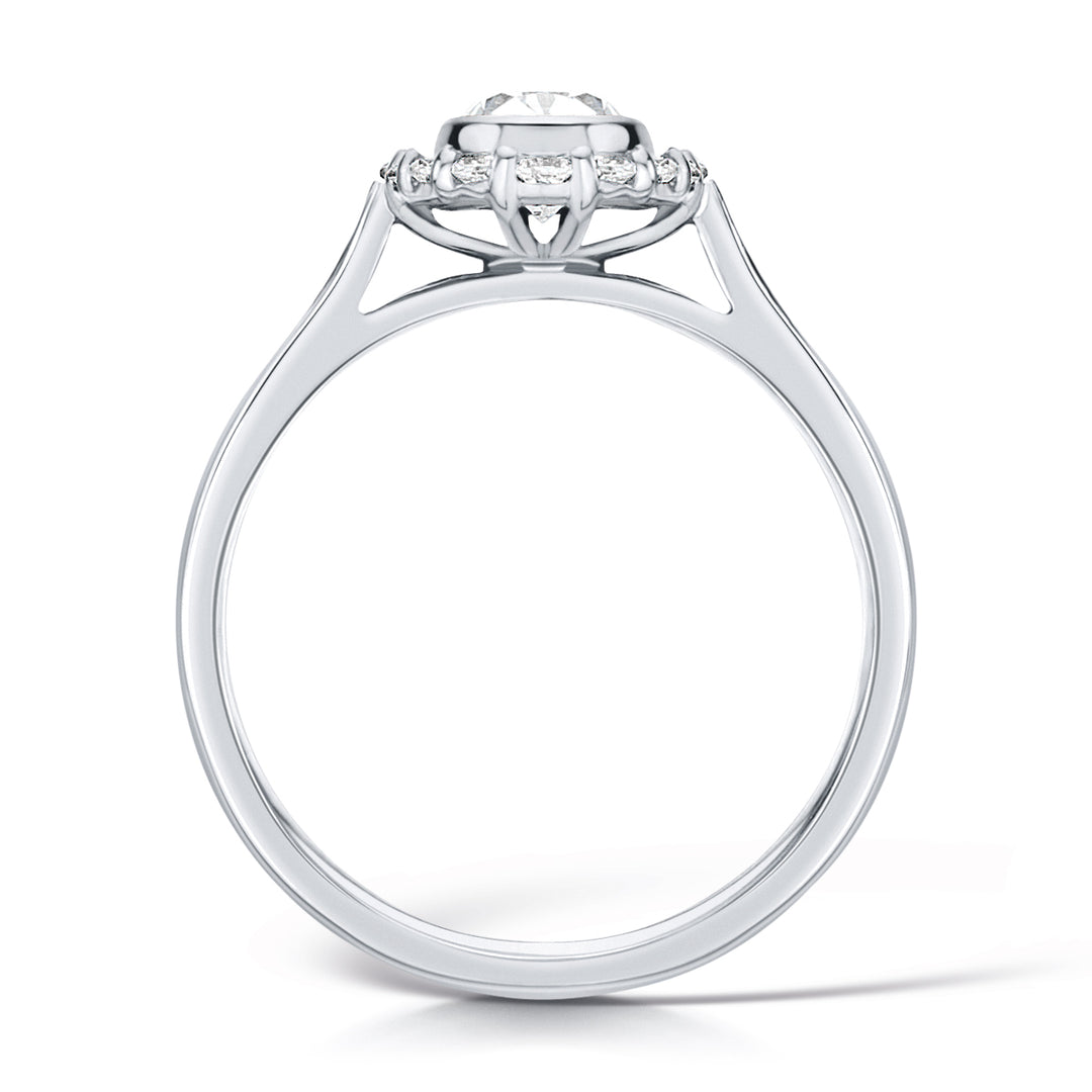 Oval Cut Diamond Ring In A Rubover Grainset Halo Design