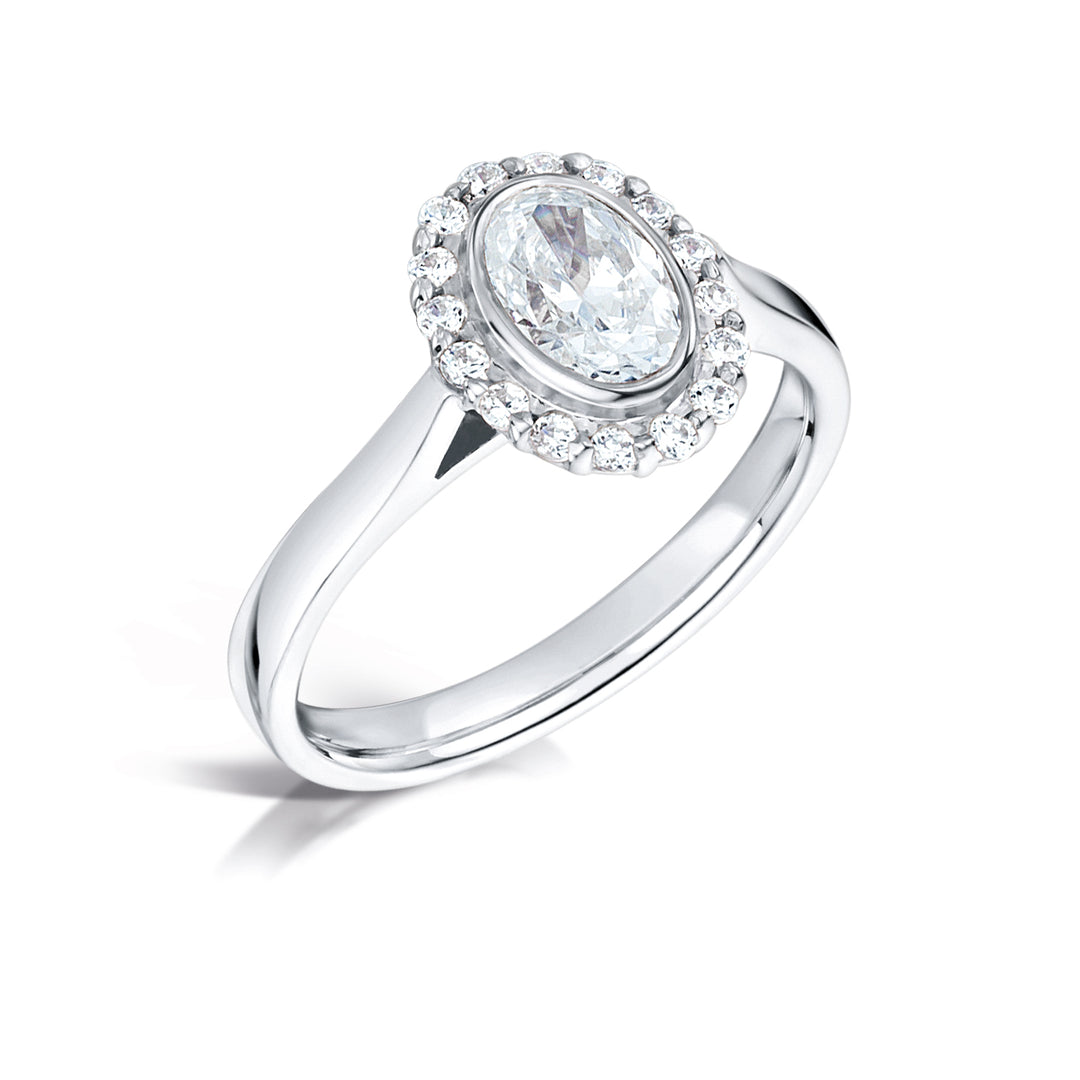 Oval Cut Diamond Ring In A Rubover Grainset Halo Design